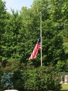 The US flag at half staff on Memorial Day at Olive Township Cemetery.