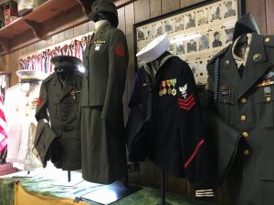 Male and female uniforms on display at Olive Township Museum.