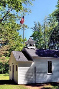 Flag flies at Pigeon Creek Schoolhouse.